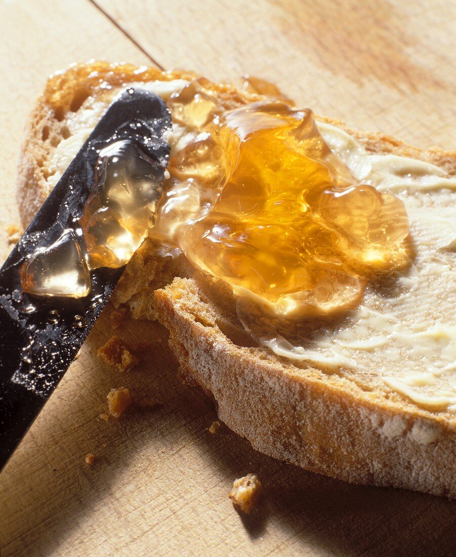 A slice of bread with apple jelly