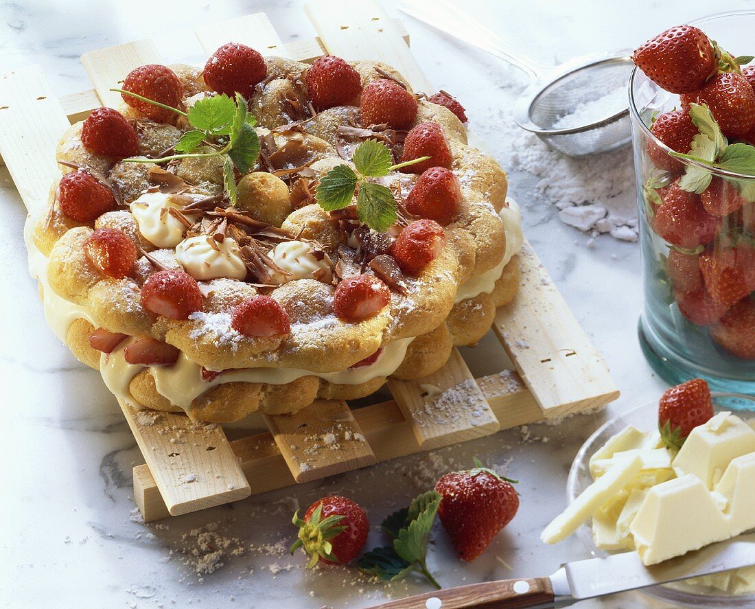 Strawberry cake with white chocolate on wooden rack