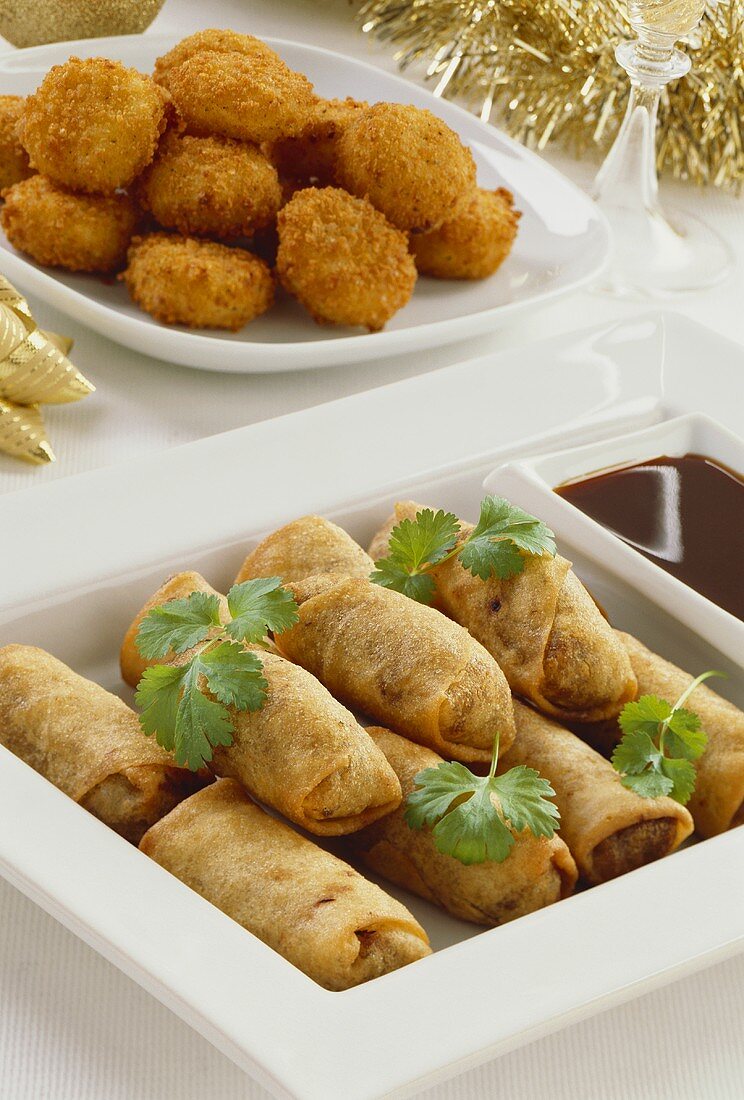 Spring rolls with soy dip, garlic cheese balls behind