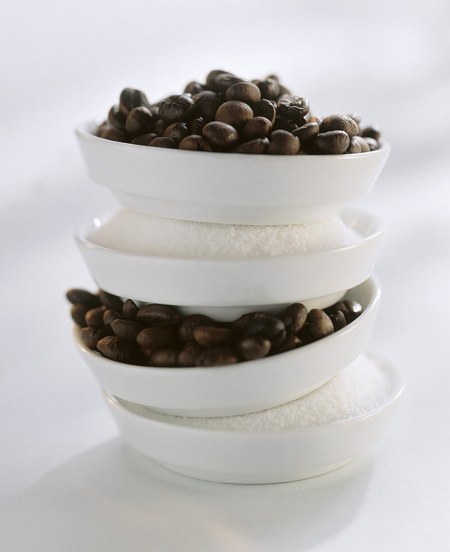 Sugar and coffee beans in a bowl, piled on top of each other