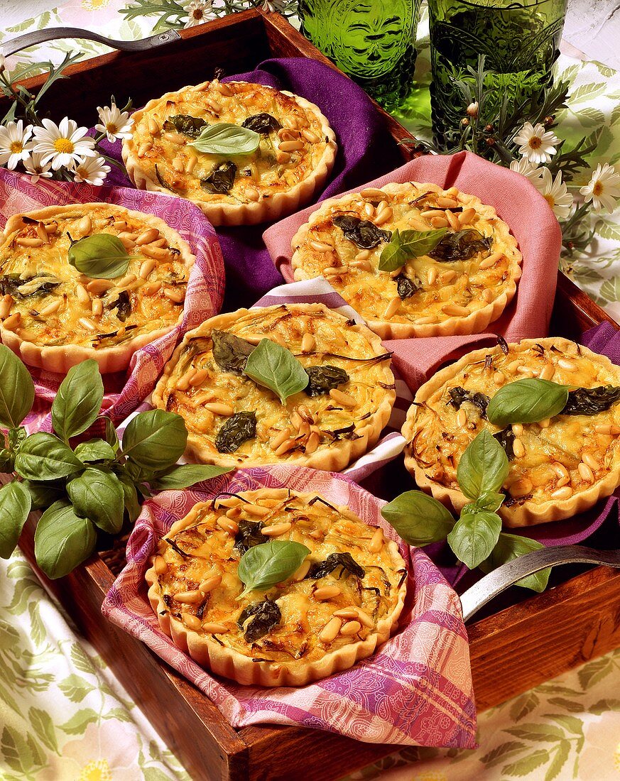 Leek tartlets with pine nuts and basil leaves
