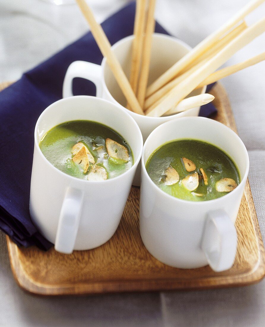 Ramsons (wild garlic) soup with garlic crisps in two cups