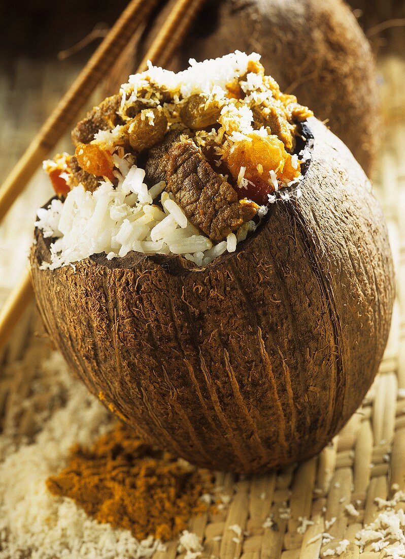 Beef with coconut rice in hollowed-out coconut