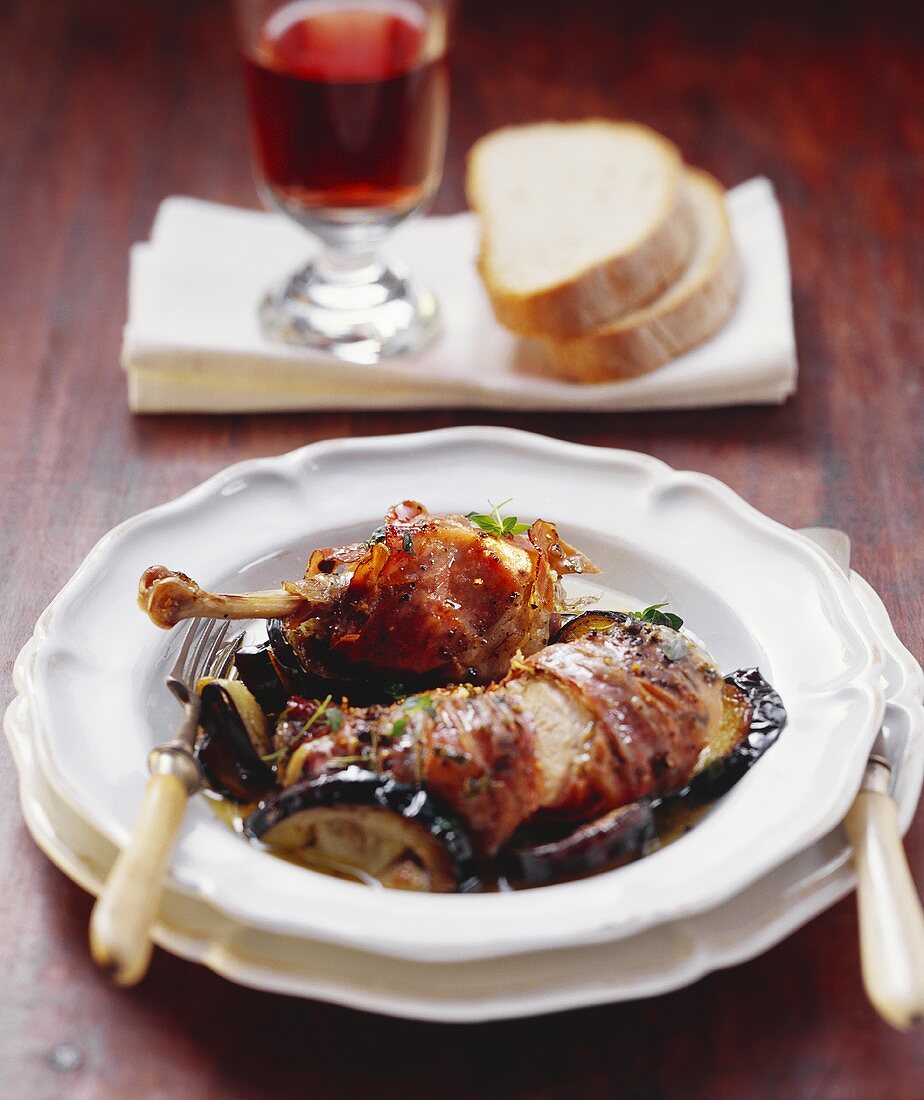 Guinea-fowl with raw ham & aubergines; glass of red wine; bread