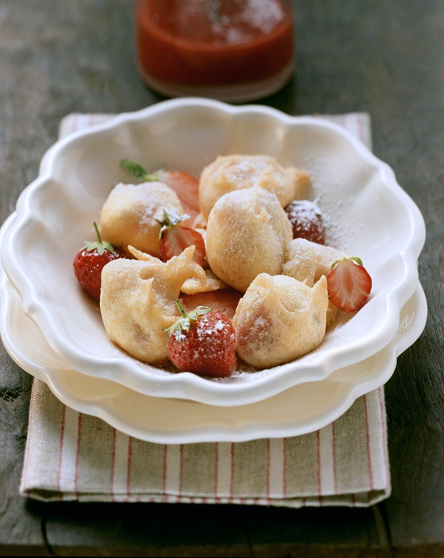 Strawberry fritters with icing sugar