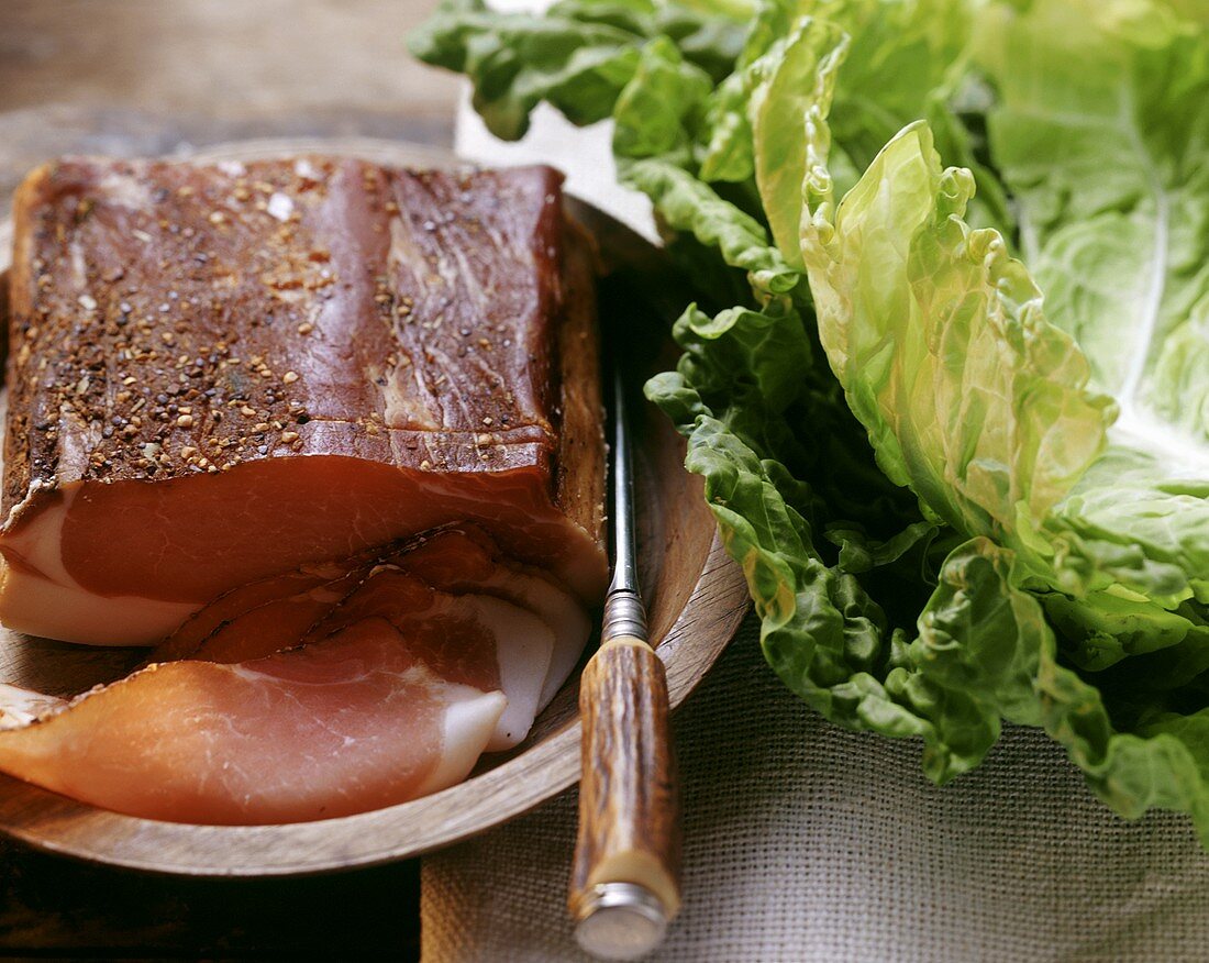 Still life with raw ham and cabbage