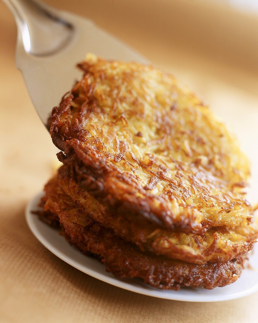 Potato rosti on plate and server