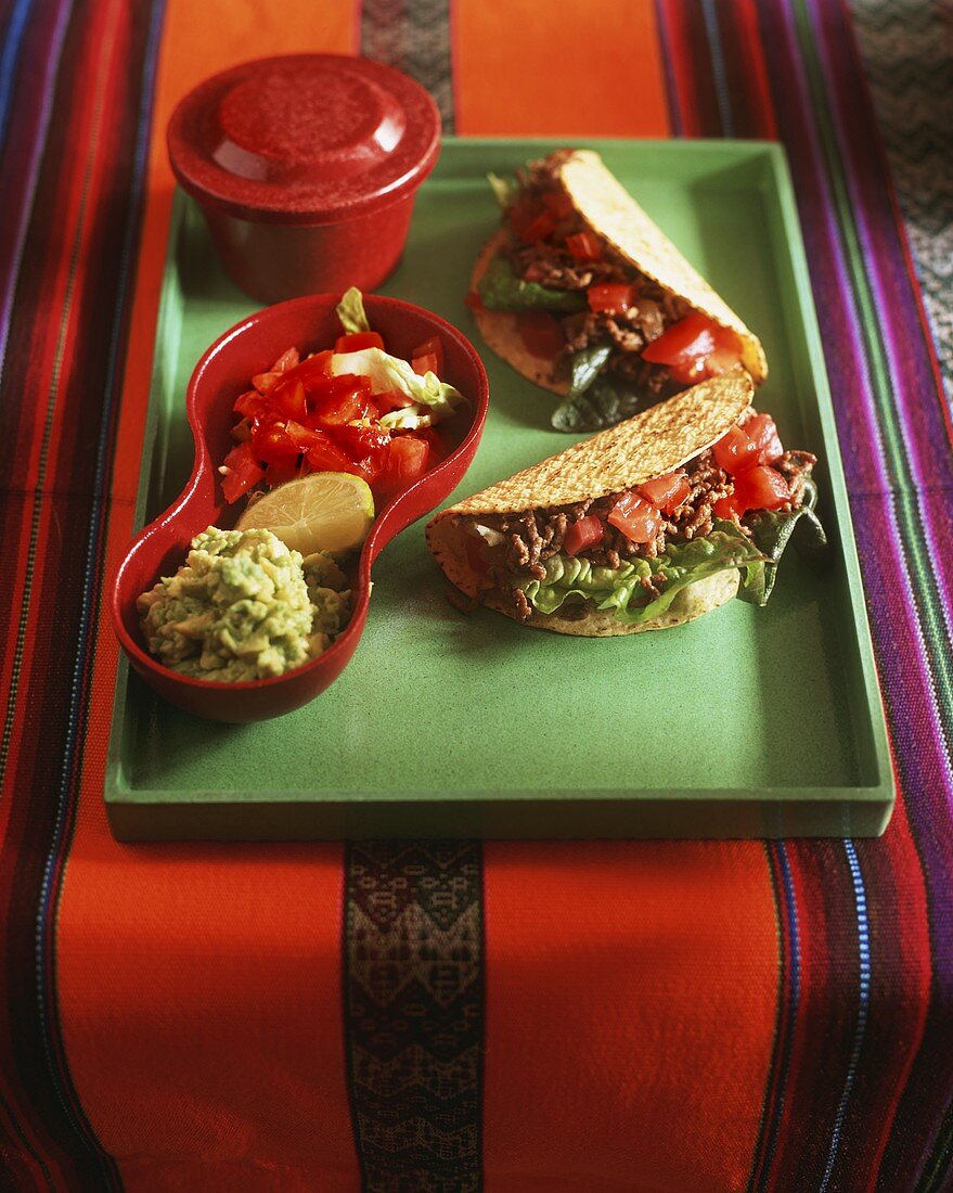 Tacos with mince filling; guacamole; salsa (Mexico)