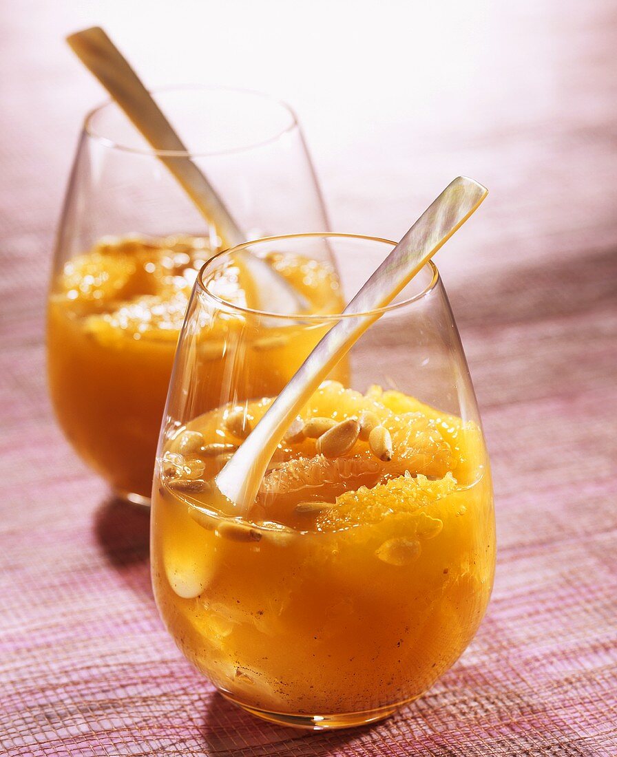 Cold citrus fruit soup with honey and pine nuts