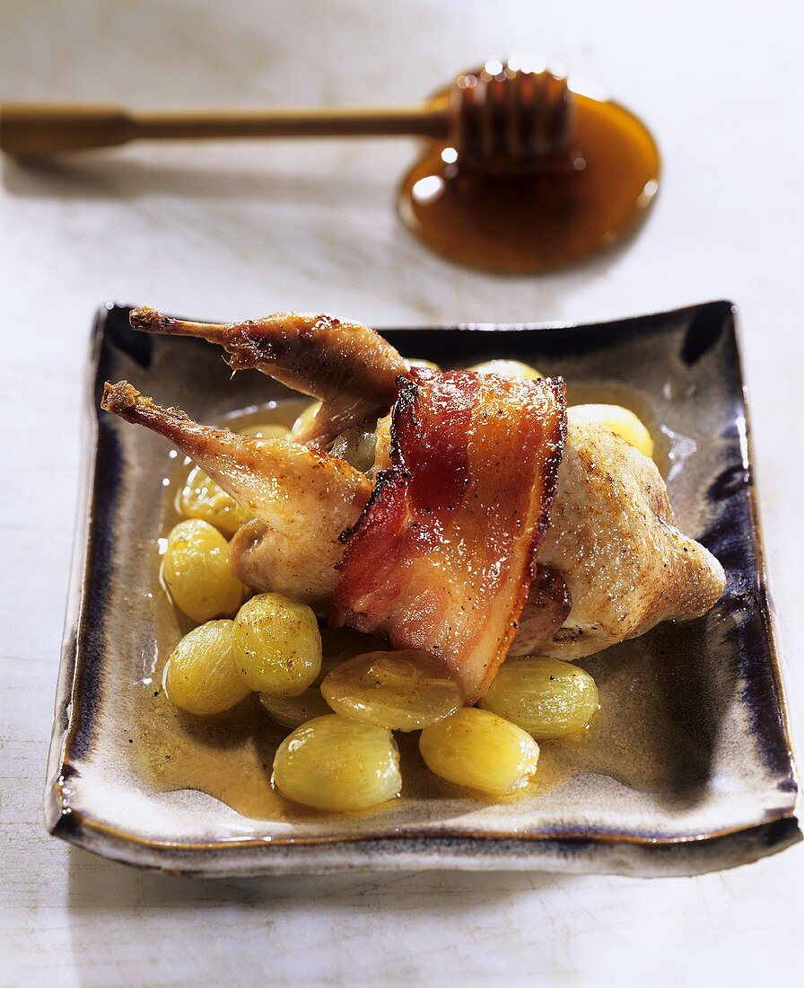 Quail with bacon, grapes and honey sauce