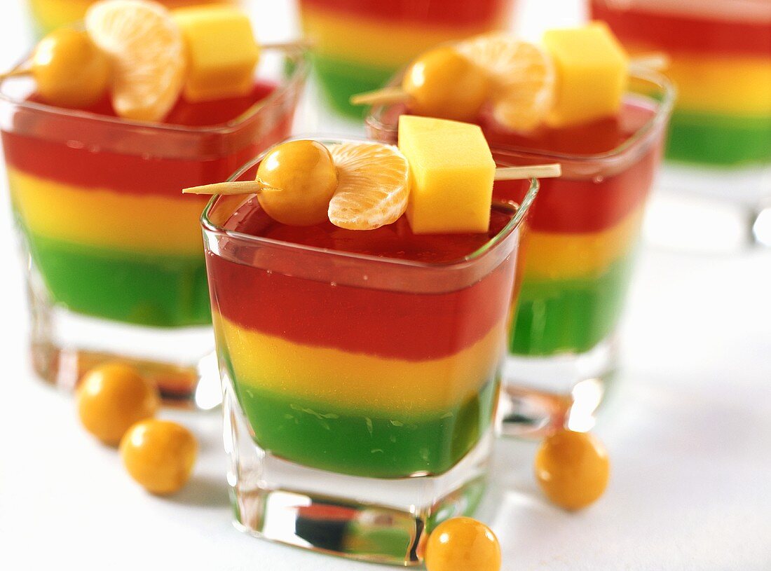 Jelly with skewered fruit in glasses