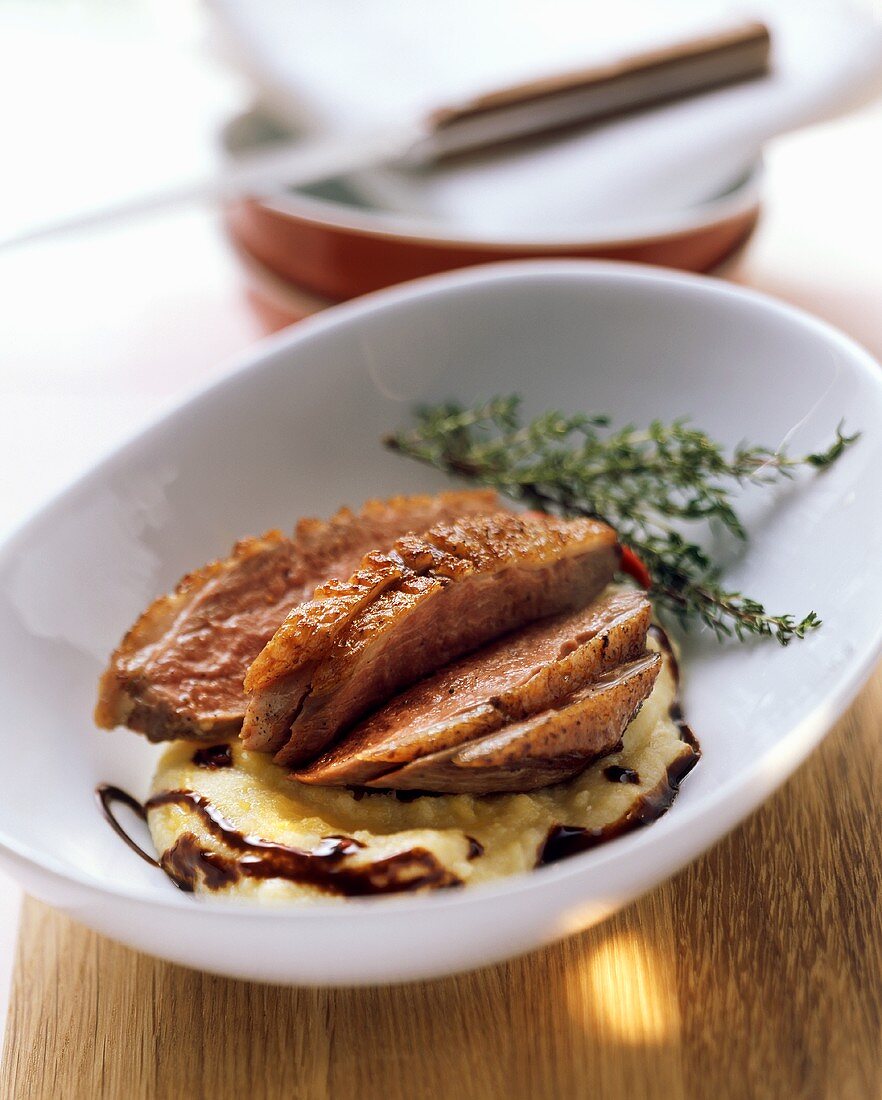 Crispy duck breast on polenta with chocolate and chili syrup