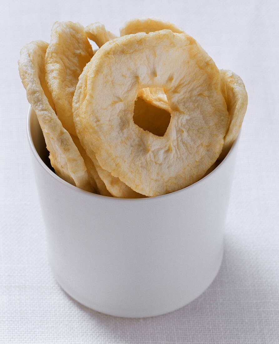 Dried apple rings in white bowl