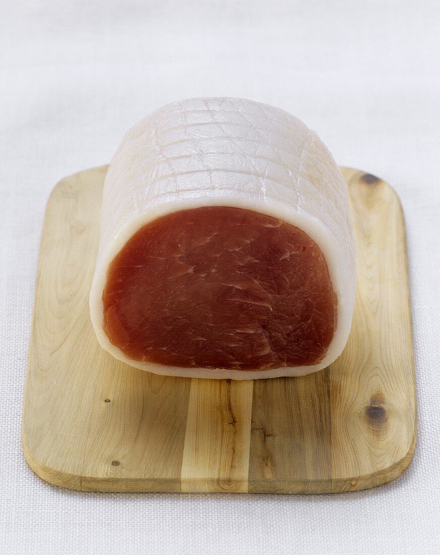 Lachsschinken ham on wooden chopping board