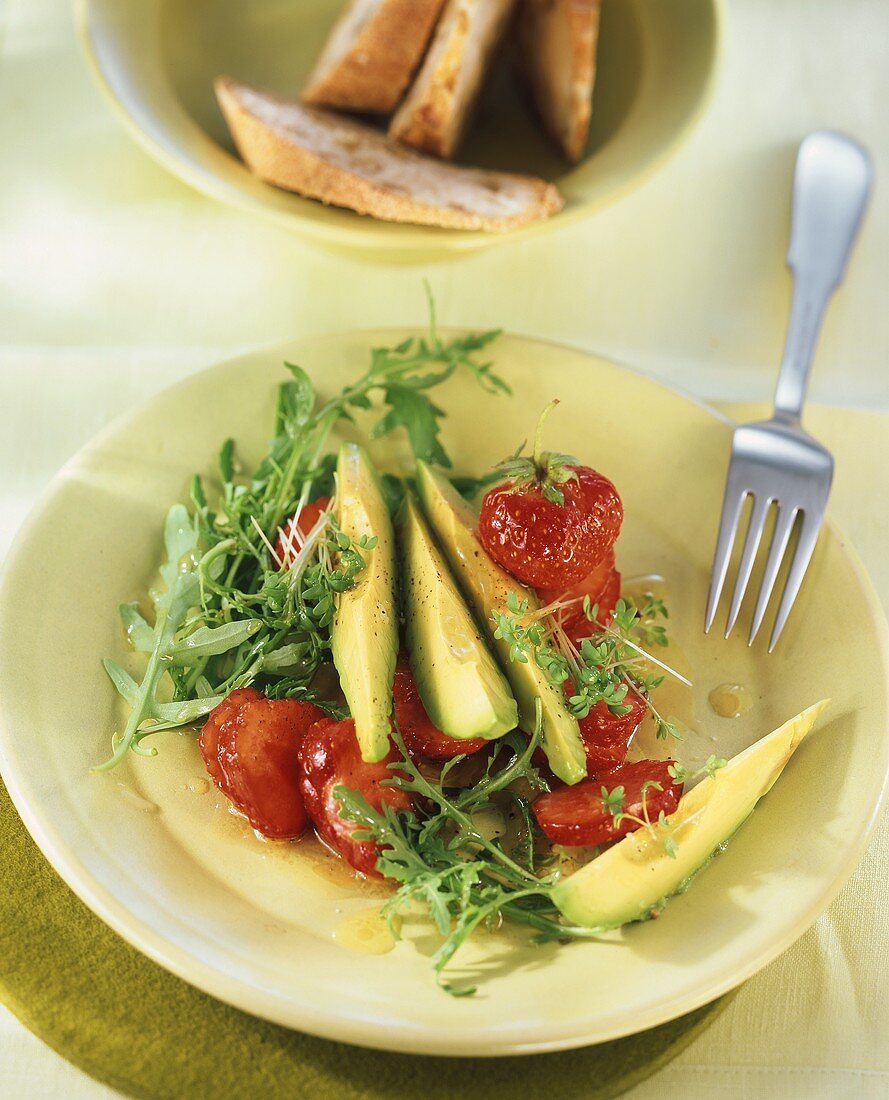 Avocado and strawberries with rocket and cress