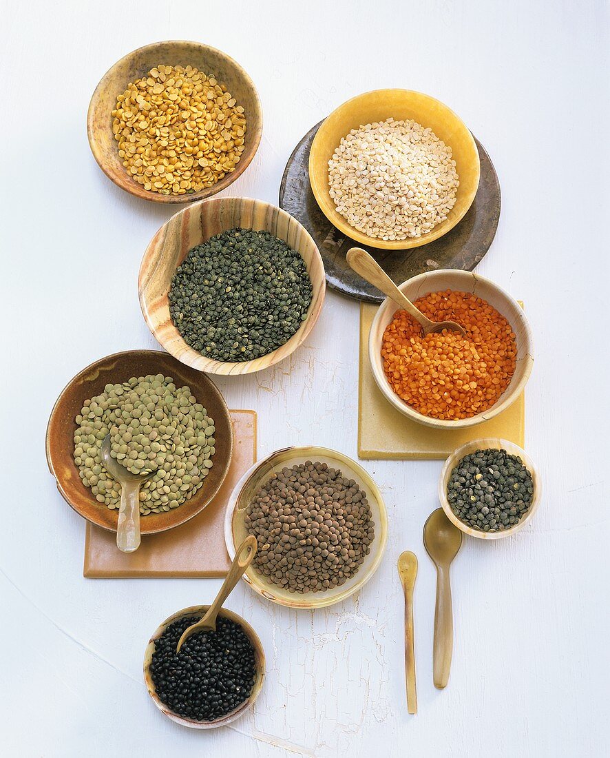 Various types of lentils in small bowls