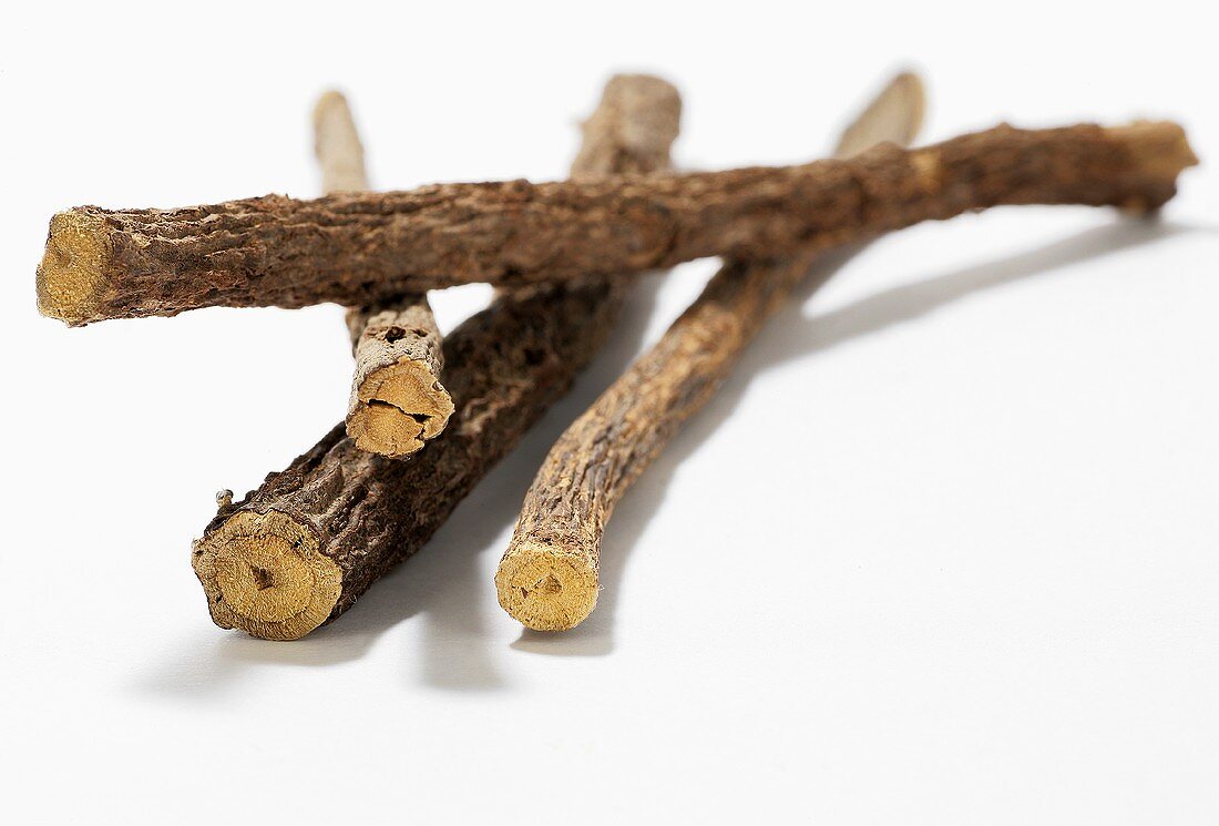 Liquorice roots on wooden background