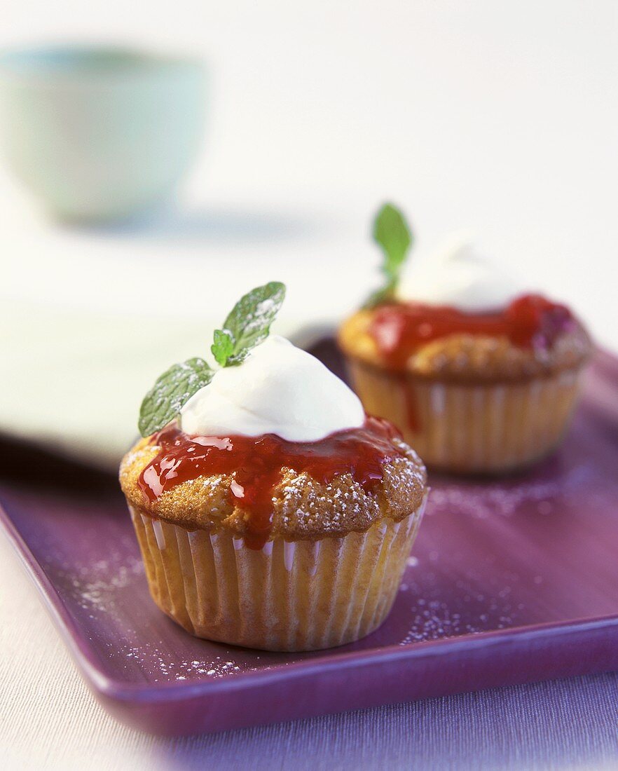 Berry muffin with cream topping and mint leaf