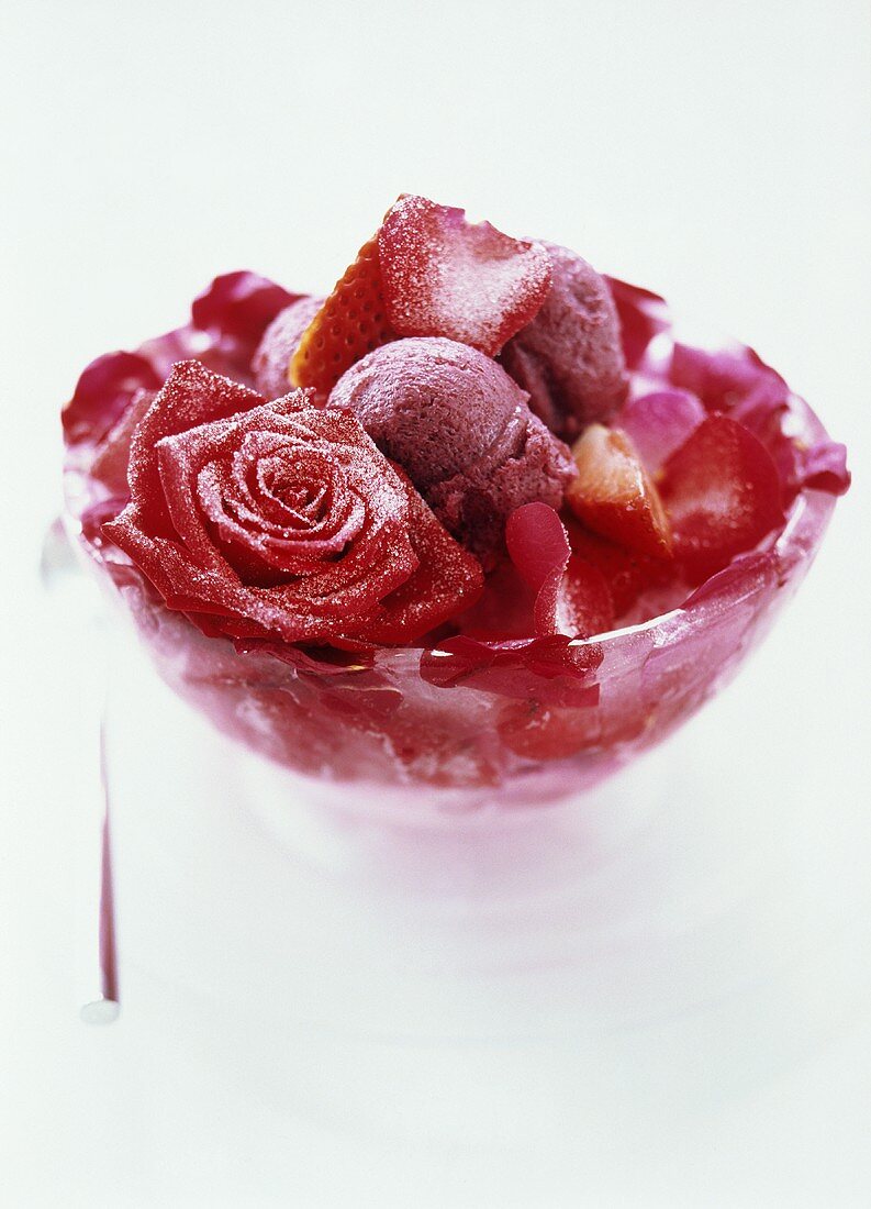 Ice cream dessert with strawberries and candied roses