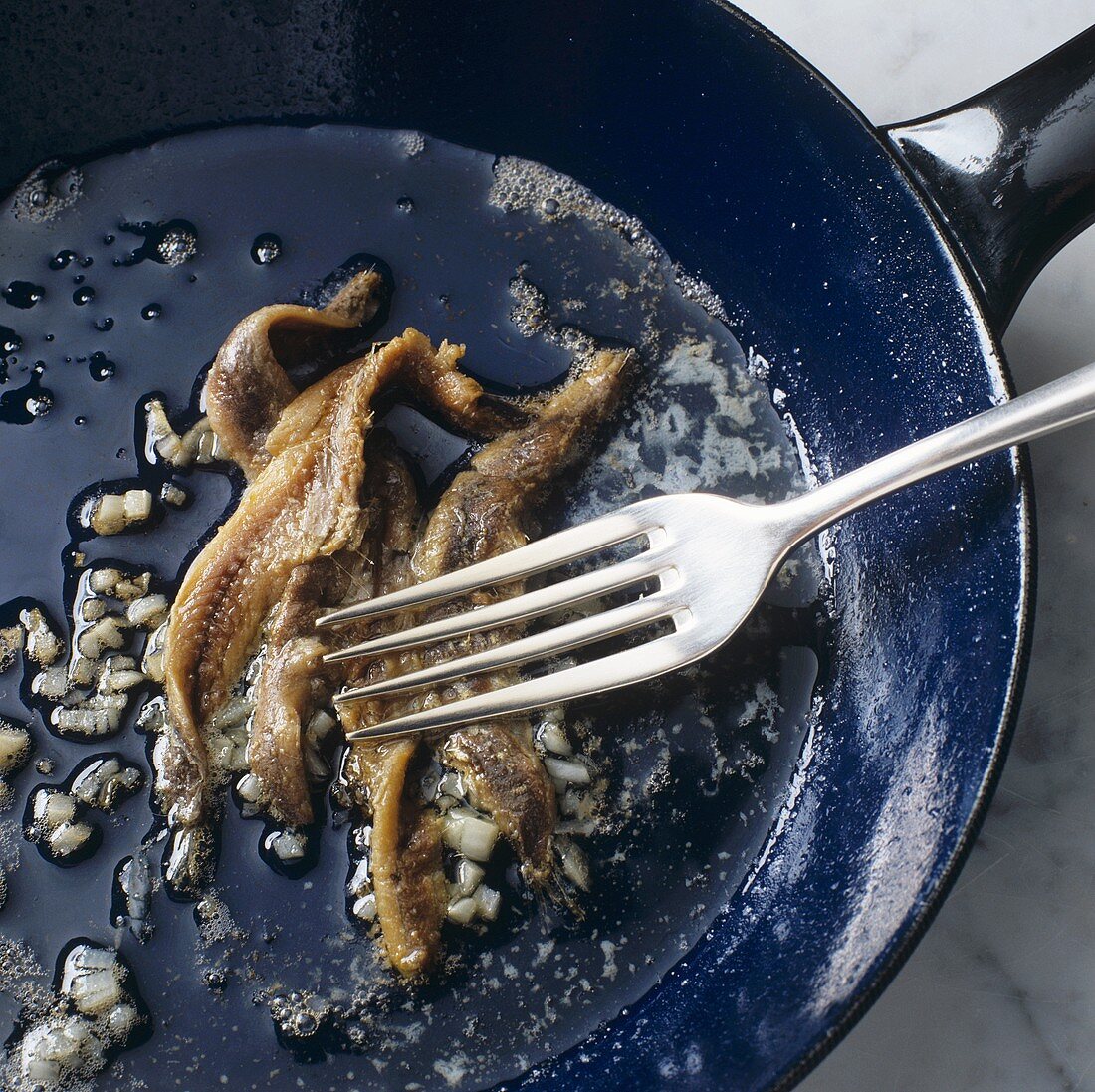 Sautéing anchovy fillets