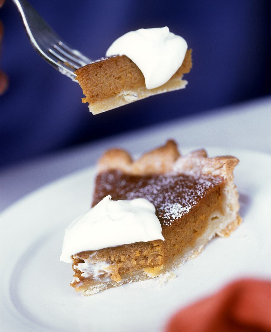 Chestnut pie with cream on plate and fork