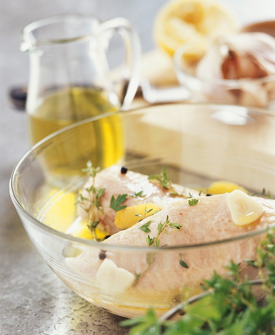 Marinating chicken with olive oil and herbs