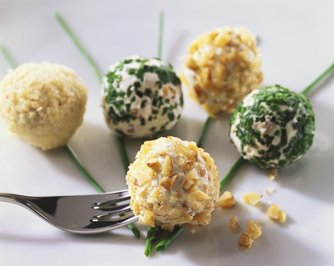 Soft cheese balls with nuts, herbs and sesame