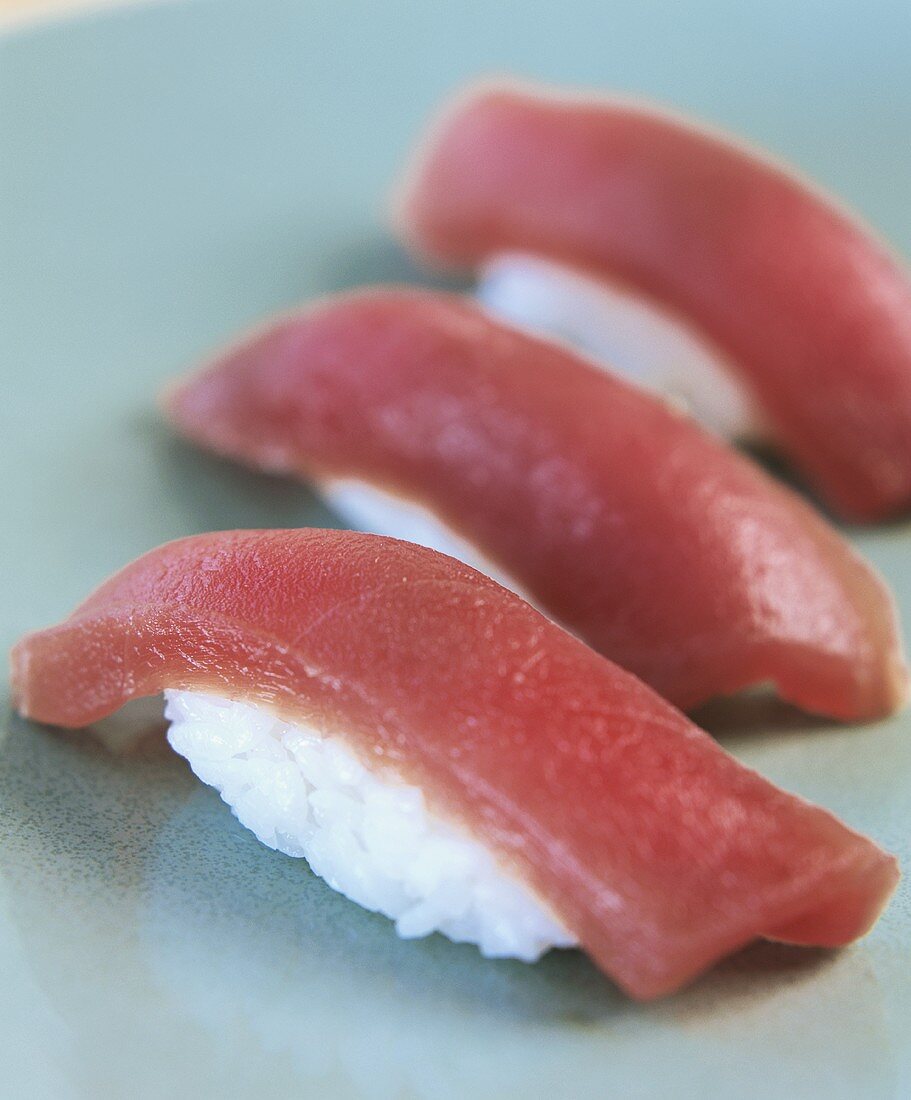 Three nigiri-sushi with tuna