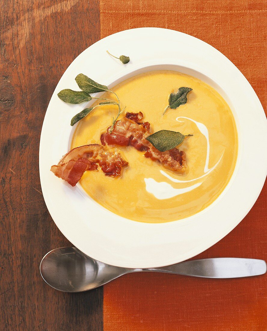 Pumpkin soup with fried bacon and sage