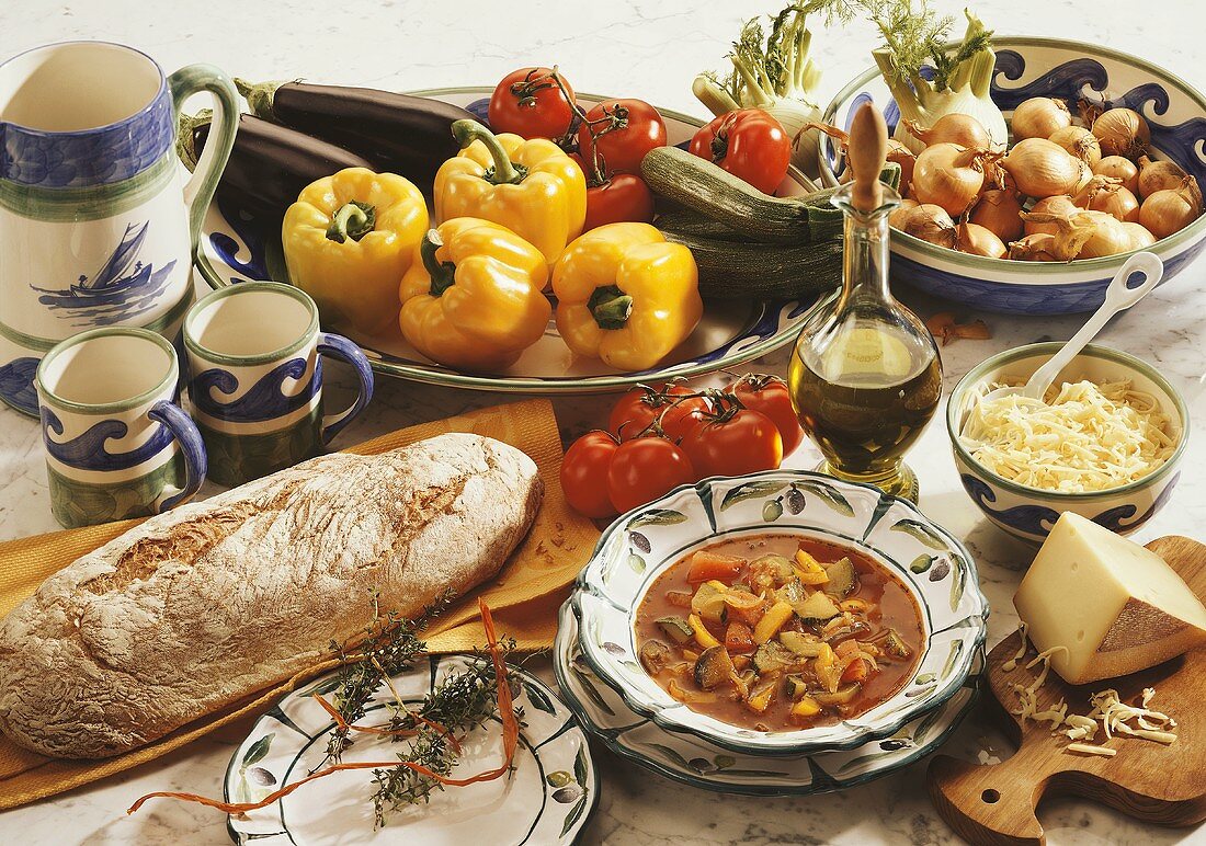 Ratatouille on plate, bread, fresh vegetables and cheese