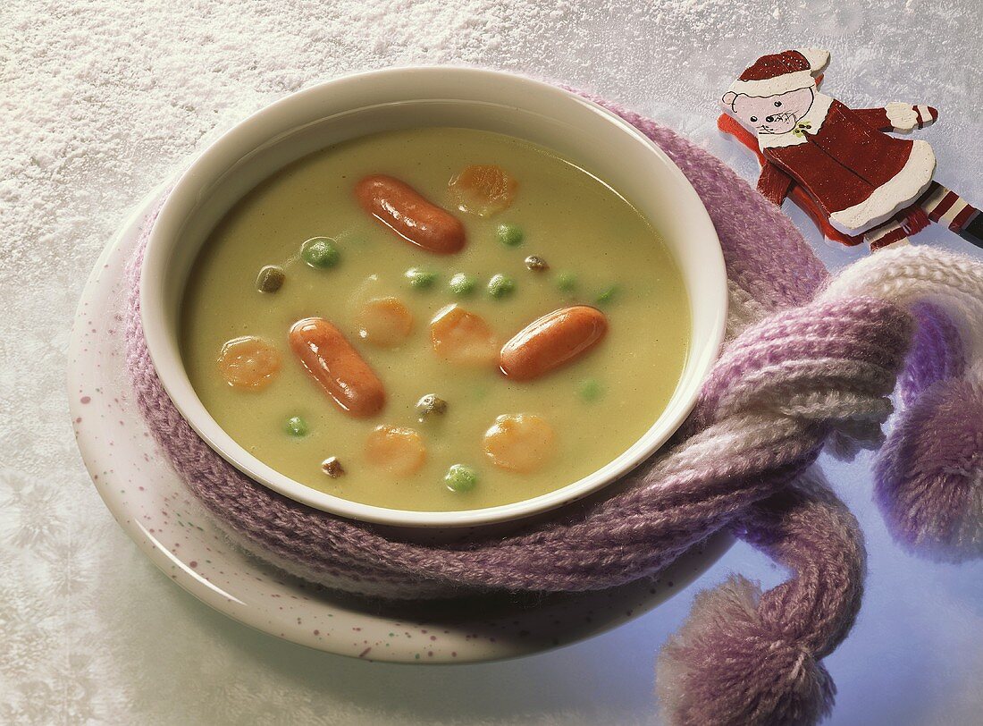 Pea soup with cocktail sausages for children