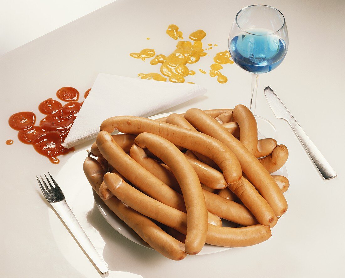 Too much meat: a heap of Frankfurters on plate