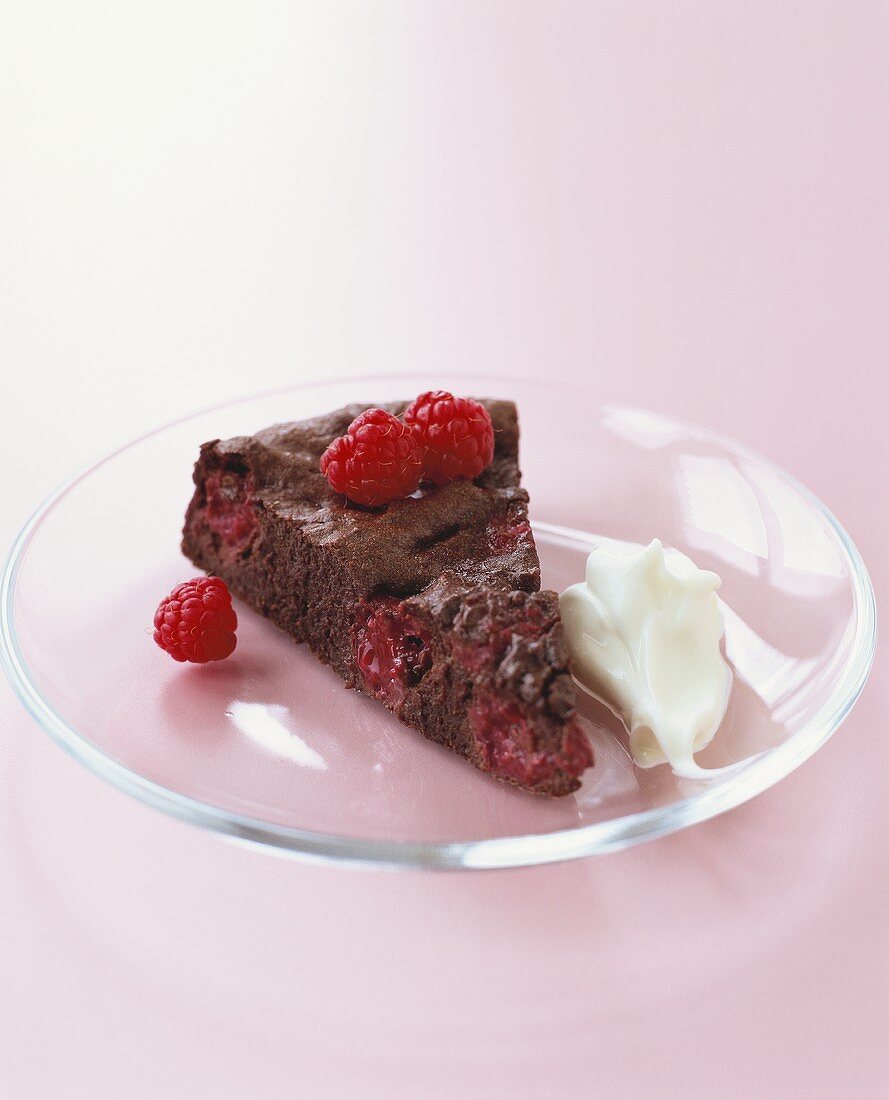 Piece of chocolate raspberry cake with cream (gluten-free)