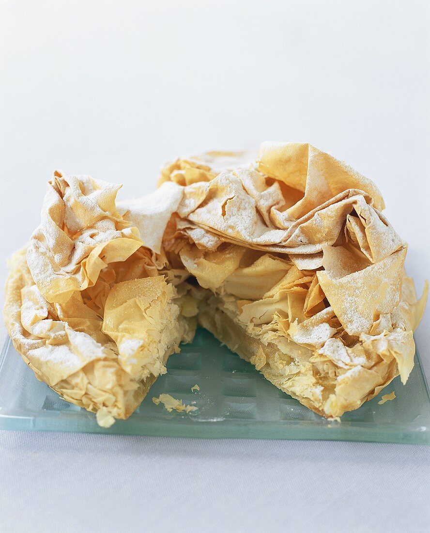 Apple pie with filo pastry crust, partly sliced