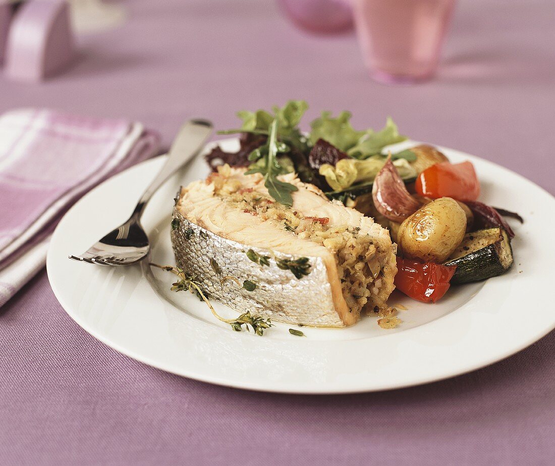 Stuffed salmon fillet with vegetables and salad