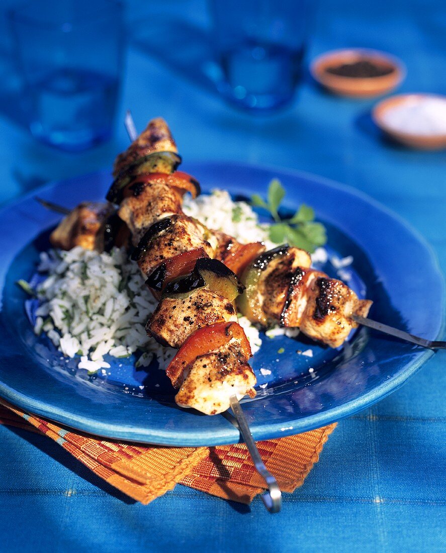 Barbecued chicken kebabs on rice