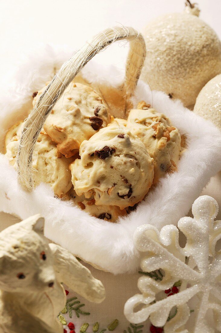 Macaroons in basket, surrounded by Christmas decorations