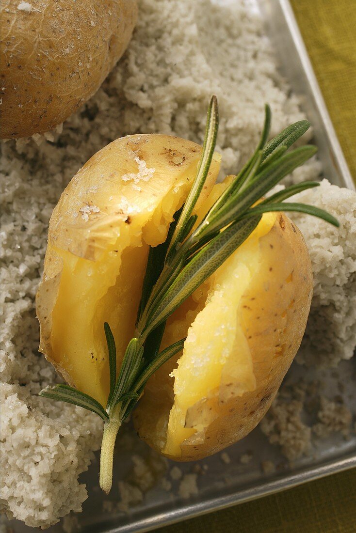 Rosemary potatoes on a bed of salt on baking tray