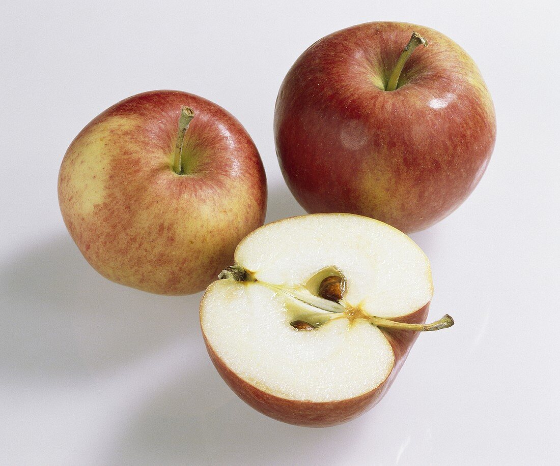 Äpfel, Sorte Jamba (Malus domestica), einer halbiert