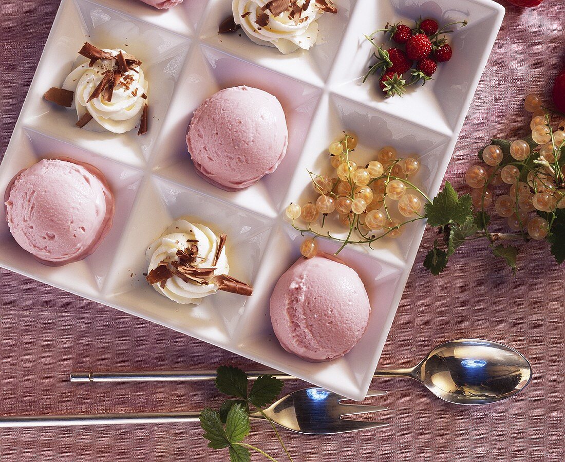 Raspberry soya yoghurt ice cream with cream and berries