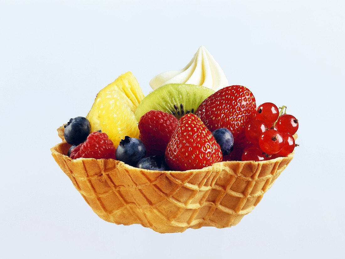 Fruit salad with cream in wafer bowl