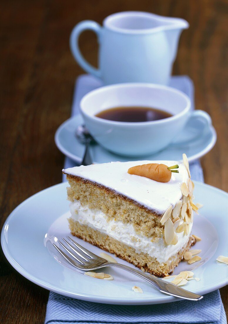 Piece of carrot cake with almonds, cup of coffee
