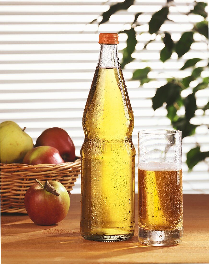 Apple juice in glass and bottle