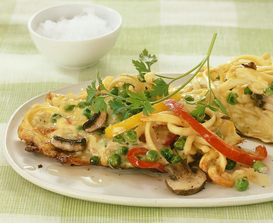 Spaetzle noodle omelette with vegetables and mushrooms