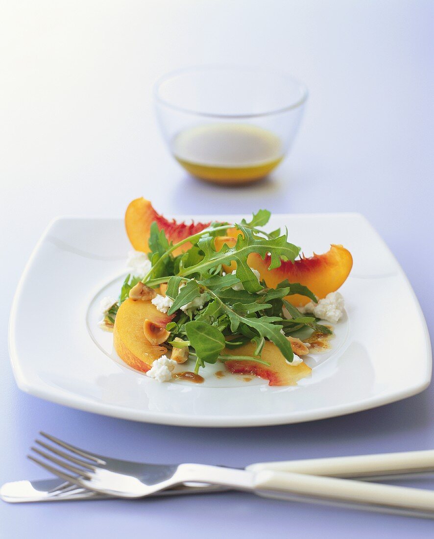 Savoury peach salad with goat's cheese, rocket and hazelnuts