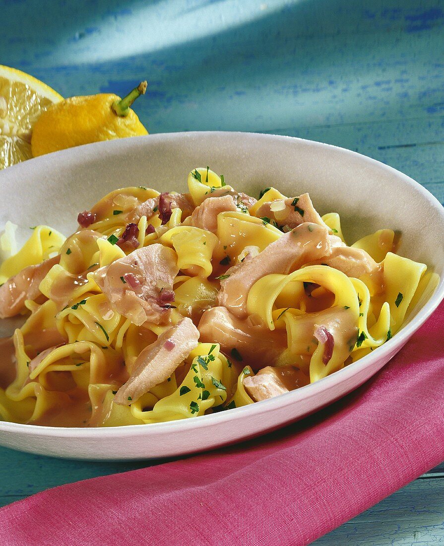 Ribbon pasta with salmon fillet and parsley