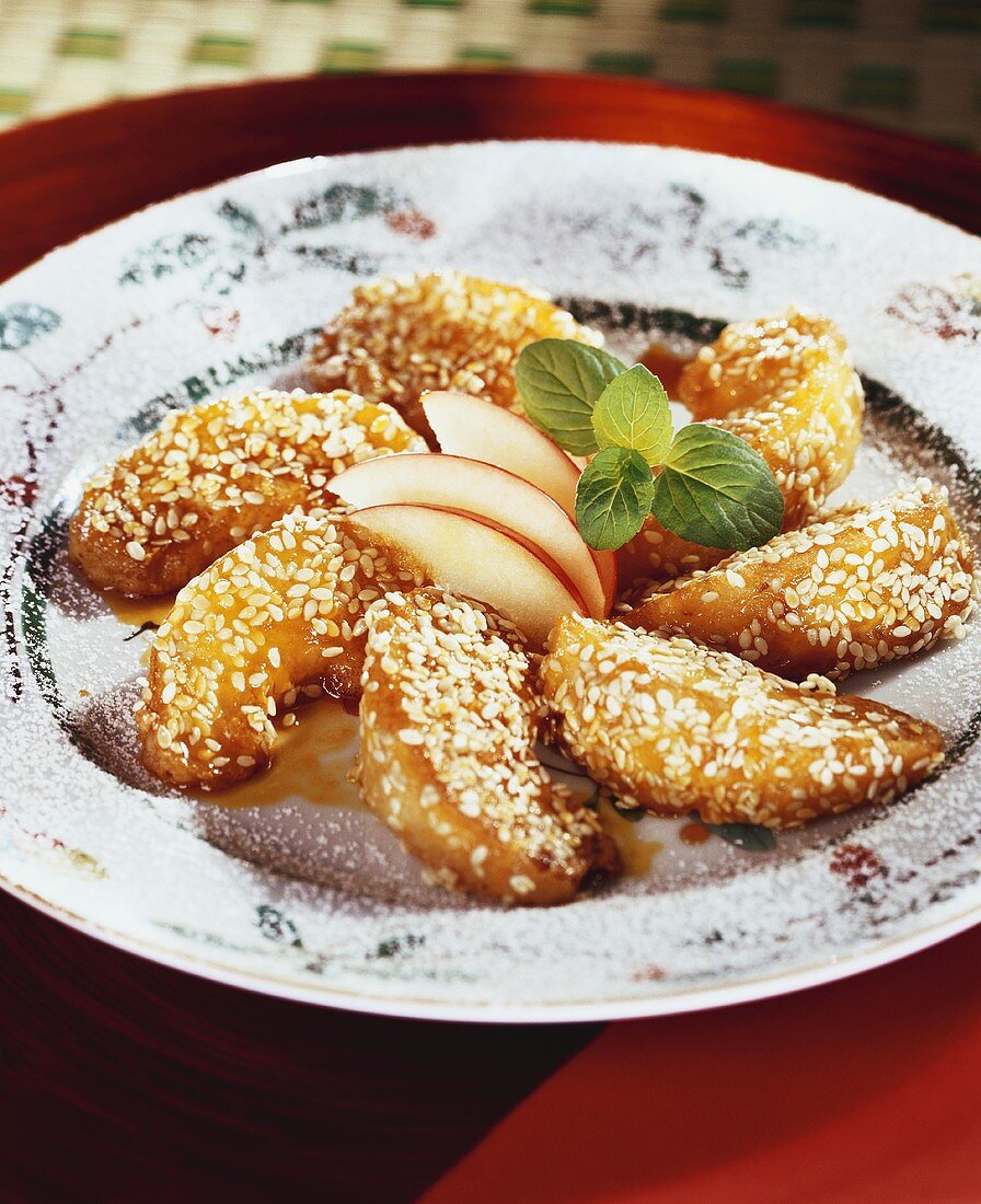 Caramelised apple wedges with sesame cooked in a wok