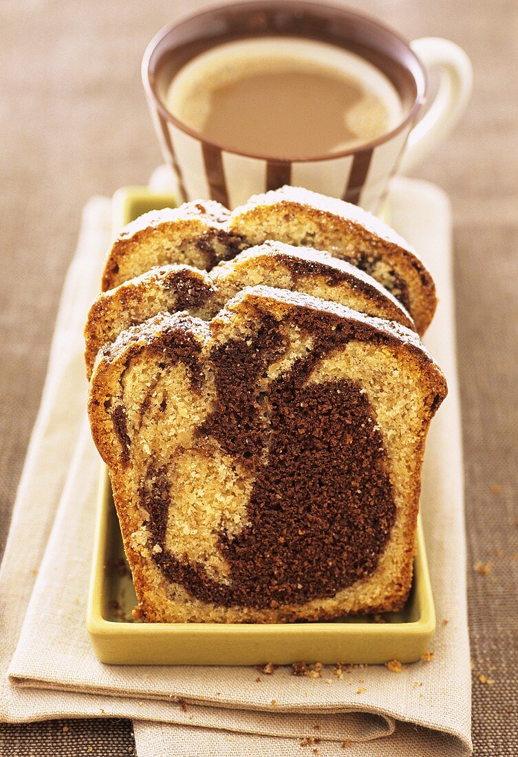 Three slices of marble cake and cup of coffee
