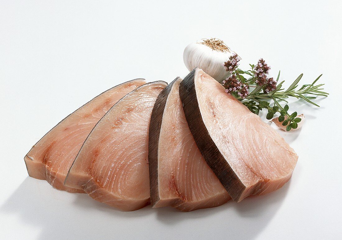 Swordfish fillets, garnished with garlic and herbs