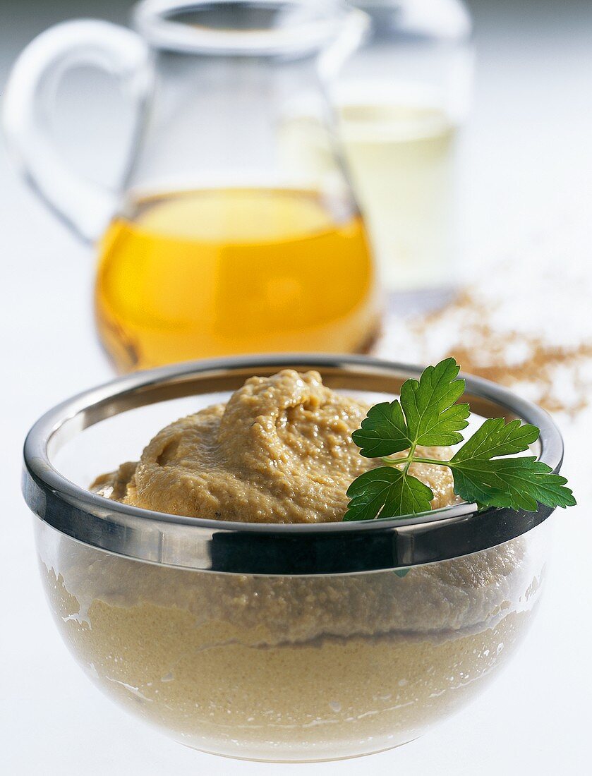 Herb mustard in small bowl with fresh parsley